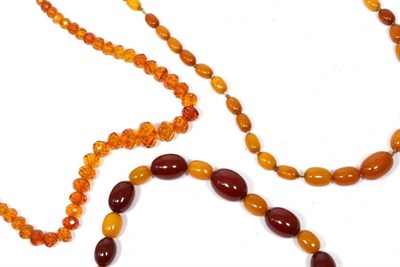 Lot 277 - An graduated amber bead necklace, length 74cm approximately, 45.1g; a red plastic and amber...
