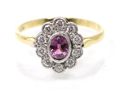 Lot 283 - A pink sapphire and diamond cluster ring, a grain set oval cut pink sapphire within a border of...