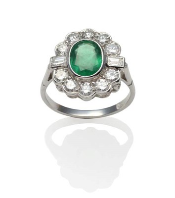 Lot 248 - An Emerald and Diamond Cluster Ring, an oval cut emerald within a border of round brilliant cut...