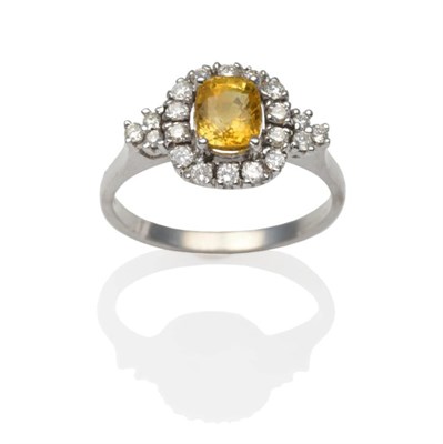 Lot 252 - An 18 Carat White Gold Yellow Sapphire and Diamond Ring, an oval cut yellow sapphire in a white...