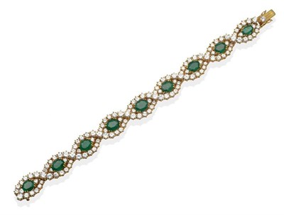 Lot 280 - An Emerald and Diamond Bracelet, articulated links each set with an oval cut emerald within a...