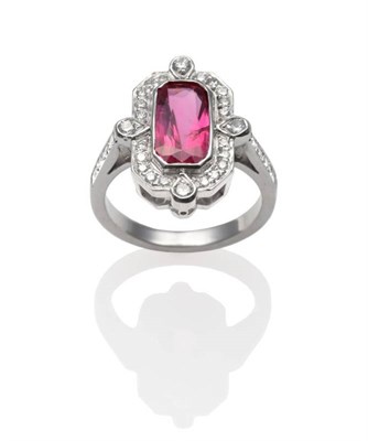 Lot 283 - An Art Deco Style Ruby and Diamond Ring, an emerald-cut ruby in a white rubbed over setting...