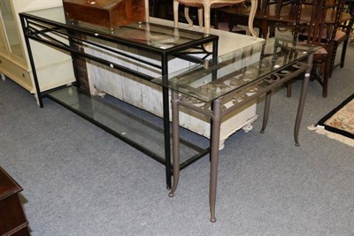 Lot 1158 - A modern glass topped console table together with another smaller example