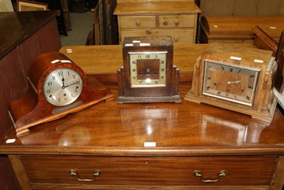 Lot 1173 - An Art Deco oak cased mantel clock; a similar walnut cased example; and a burr walnut cased...