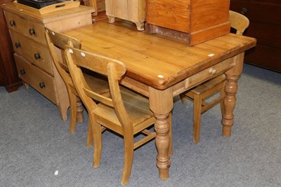 Lot 1180 - A pine kitchen table together with four dining chairs