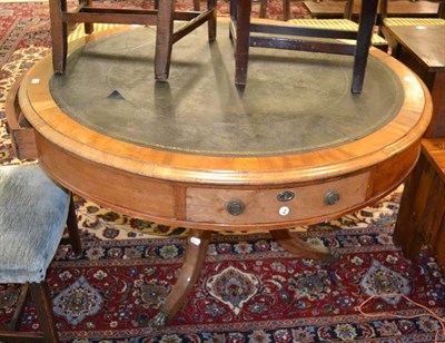 Lot 1208 - A circular mahogany rent type table, fitted with four drawers, two with numbered plaques, two...