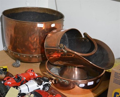 Lot 1216 - A copper log bin, on lion paw supports; a twin handled jam pan; bed warmer and a coal scuttle