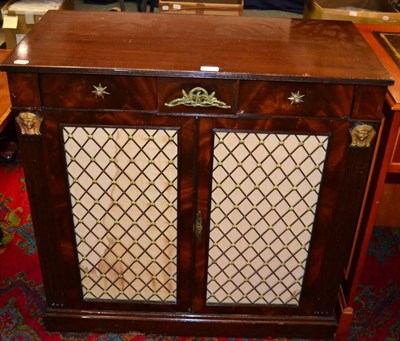 Lot 1233 - A pair of Regency style mahogany brass grill door cabinets