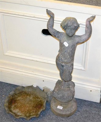 Lot 1242 - A cast metal bird bath modelled as a boy holding shell aloft