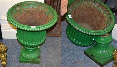 Lot 1243 - A pair of cast iron garden urns, green painted (one in two parts)