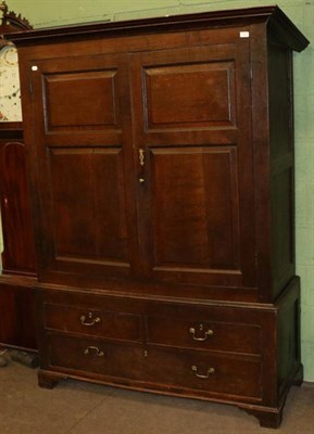 Lot 1268 - A mid 18th century oak press cupboard, the bold cornice above fielded panel cupboard doors...