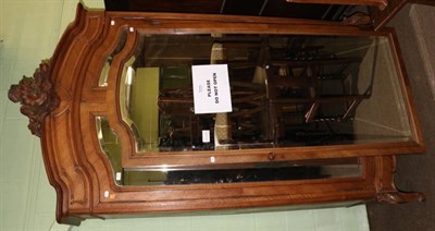 Lot 1274 - A French Louis XV style walnut armoire, late 19th century, the carved pediment above bevelled glass