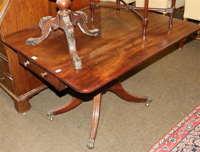 Lot 1297 - An early 19th century mahogany Pembroke table on turned support and four outswept supports,...