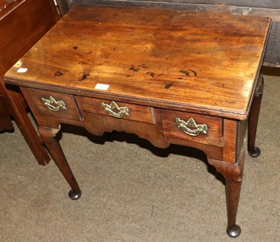 Lot 1329 - An 18th century mahogany lowboy on pad feet