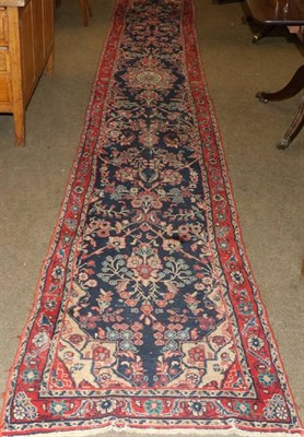 Lot 1342 - Narrow Lilihan runner, West Iran, the indigo floral field enclosed by narrow borders, 533cm by 77cm