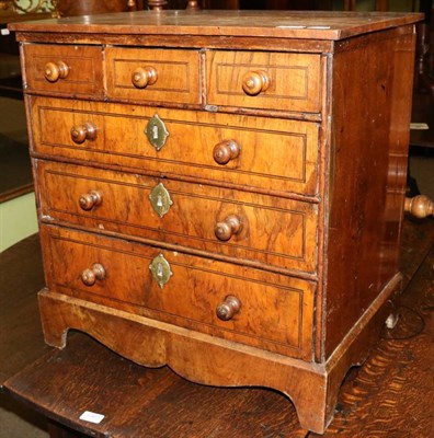 Lot 1366 - A George II walnut, boxwood and ebony strung miniature chest, of three short over three long...