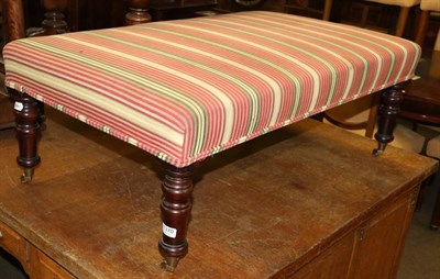 Lot 1370 - A modern upholstered stool/Ottoman on turned supports and castors