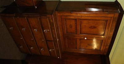 Lot 1394 - An oak and mahogany cross banded cupboard on chest with shell inlaid doors