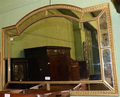 Lot 1395 - A 19th century gilt and gesso overmantel mirror, arched top with segmented border, moulded frame