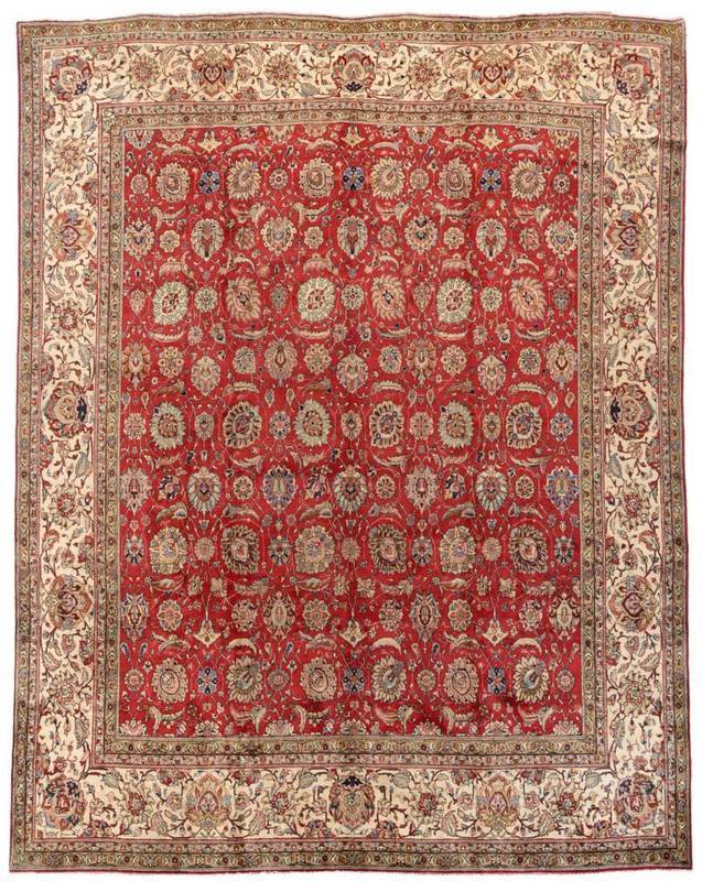 Lot 849 - Tabriz Carpet of unusual size Iranian Azerbaijan The deep brick red field with an allover design of