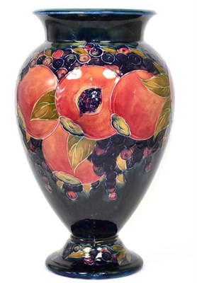 Lot 225 - William Moorcroft (1872-1945): A Large Open Pomegranate Pattern Pedestal Vase, on a blue...