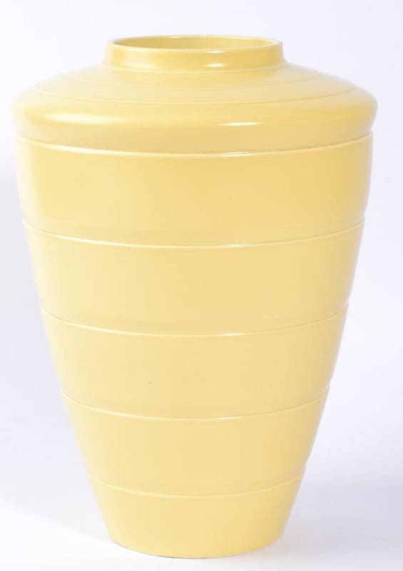 Lot 274 - Keith Murray (New Zealander 1892-1981) for Wedgwood, a tapering vase, ribbed body, pale yellow...