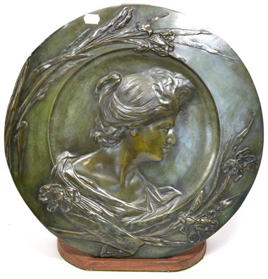 Lot 300 - An Art Nouveau Bronze Charger, cast with the profile of a maiden, within a iris border, signed...