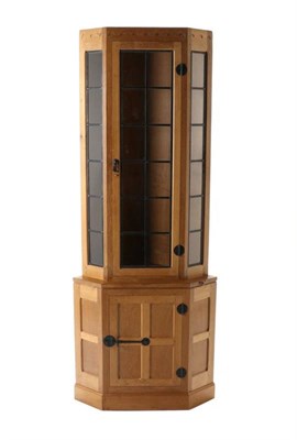 Lot 304 - Mouseman: A Robert Thompson English Oak Corner Display Cupboard, the upper section with leaded...