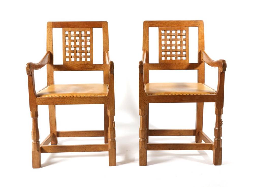 Lot 307 - Mouseman: A Pair of Robert Thompson English Oak Lattice Back Arm Chairs, nail tan hide seats,...