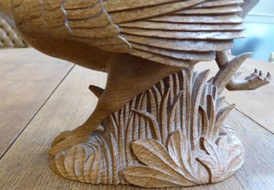 Lot 313 - Mouseman: A Robert Thompson Carved English Oak Pheasant, in a running pose, with carved mouse...