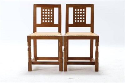 Lot 325 - Mouseman: Two Robert Thompson English Oak Lattice Back Dining Chairs, nail tan hide seats, on...