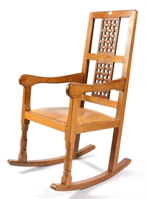 Lot 369 - A Sid Pollard (Thirsk) English Oak Rocking Chair, with two lattice panels, on octagonal front legs