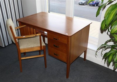 Lot 401 - A 1960's Gordon Russell Teak Desk and Chair, the desk with a rectangular top over a bank of...