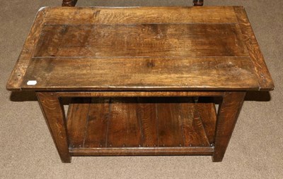 Lot 404 - A 1970s Teak Rectangular Coffee Table, the tray shaped top above four legs joined by a shaped...