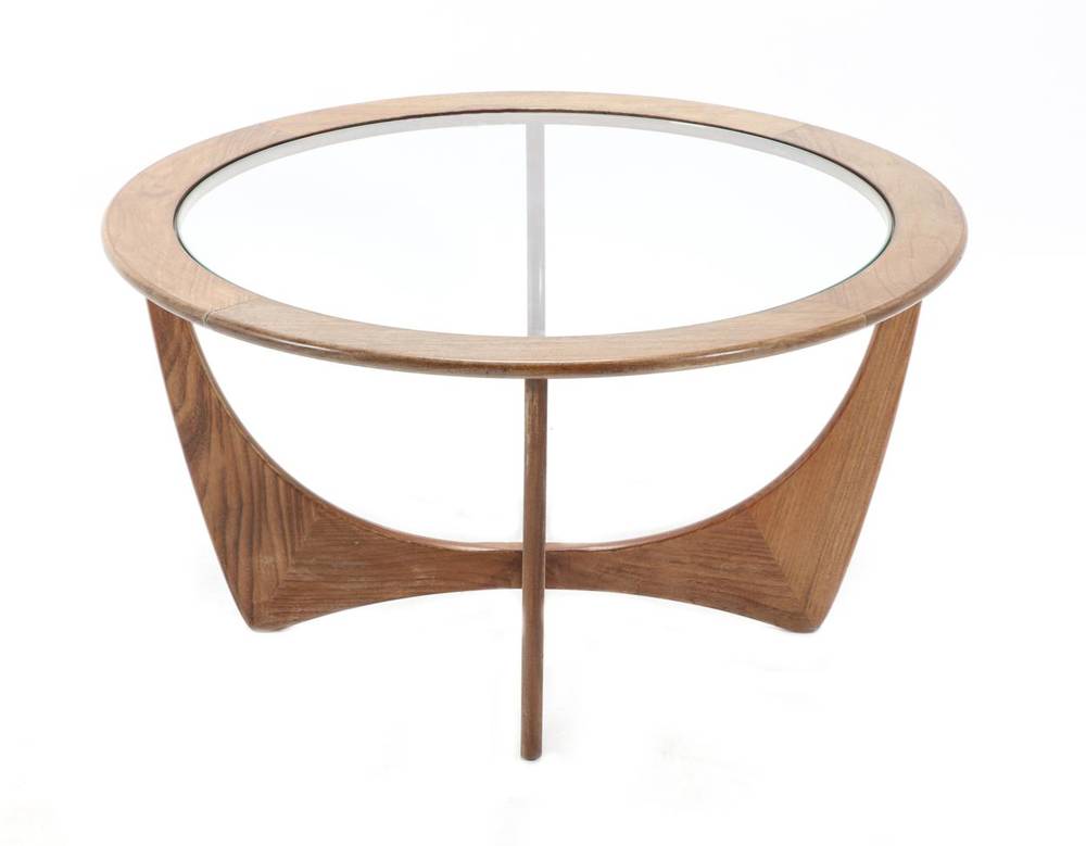 Lot 405 - A 1970s G-Plan Teak Coffee Table, the circular top with glass, on shaped supports, labelled,...