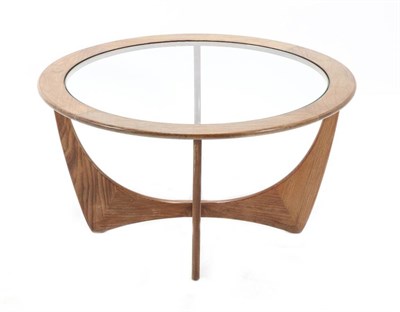 Lot 405 - A 1970s G-Plan Teak Coffee Table, the circular top with glass, on shaped supports, labelled,...