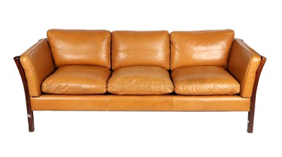 Lot 414 - Stouby: A 1970s Three-Seater Orange Tan Leather Three-Seater Sofa, with mahogany effect frame,...