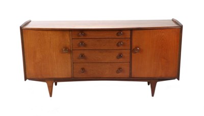 Lot 426 - A Younger Ltd: A 1970s Eight Piece Teak Dining Suite, comprising a bowfront sideboard with four...