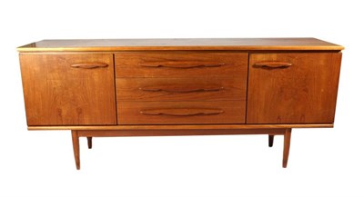 Lot 427 - A 1970s Teak Long John Sideboard, with three central drawers flanked by cupboard doors...