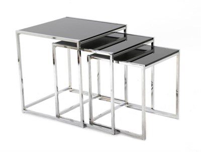 Lot 440 - A Nest of Three Polished Chrome and Smoked Glass Tables, of square tapering form, the largest...