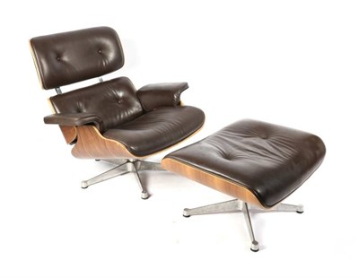 Lot 442 - After Charles and Ray Eames: A Walnut 670 Lounge Chair and 671 Ottoman, modern, with brown...