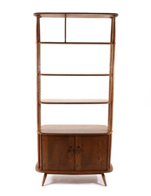 Lot 471 - An Ercol Originals Style Elm Room Divider, with two adjustable shelves, the base with cupboard...