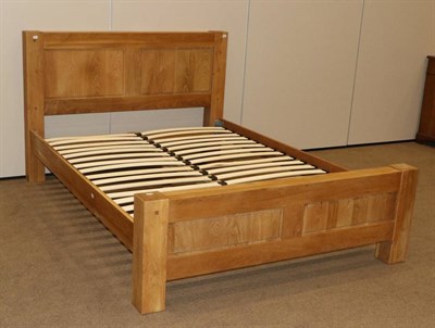 Lot 481 - A Solid Oak Bedstead, with panelled headboard and footboard, with square form legs and solid...