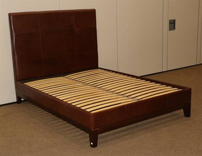 Lot 489 - A 5ft Brown Leather Bedstead, modern, with a tall padded headboard with leather covered side...