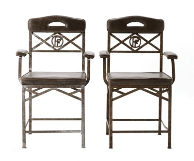 Lot 506 - A Pair of Early 20th Century French Wrought Iron Armchairs, recovered in vintage brown leather, the