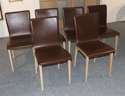 Lot 516 - Ligne Roset: A Set of Six Brown Leather and Oak Dining Chairs, modern, 44cm by 47cm by 88cm