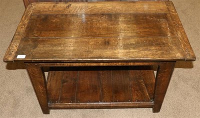 Lot 534 - An Oak Plank Top Coffee Table, modern, with cleated ends, on tapering legs joined by a shelf,...