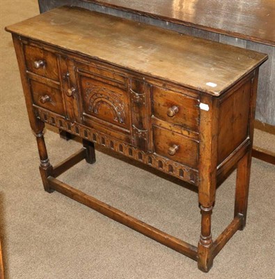 Lot 538 - A Titchmarsh & Goodwin Oak Side Cabinet, modern, unmarked, with carved cupboard door flanked by two