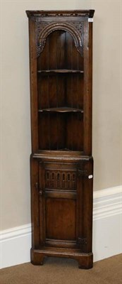 Lot 539 - Ledgard & Wynn Ltd: A Carved Oak Free-Standing Corner Cupboard, modern, in two halves, the top with