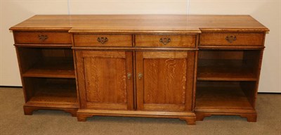 Lot 541 - A Reproduction Oak Breakfront Sideboard, with four drawers above a central two-door cupboard...